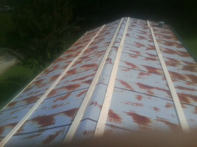 Rusted metal roof panels with new wood purlins before replacement — Storm Damage Roof Repair in Mc Bee by Roofing Brothers